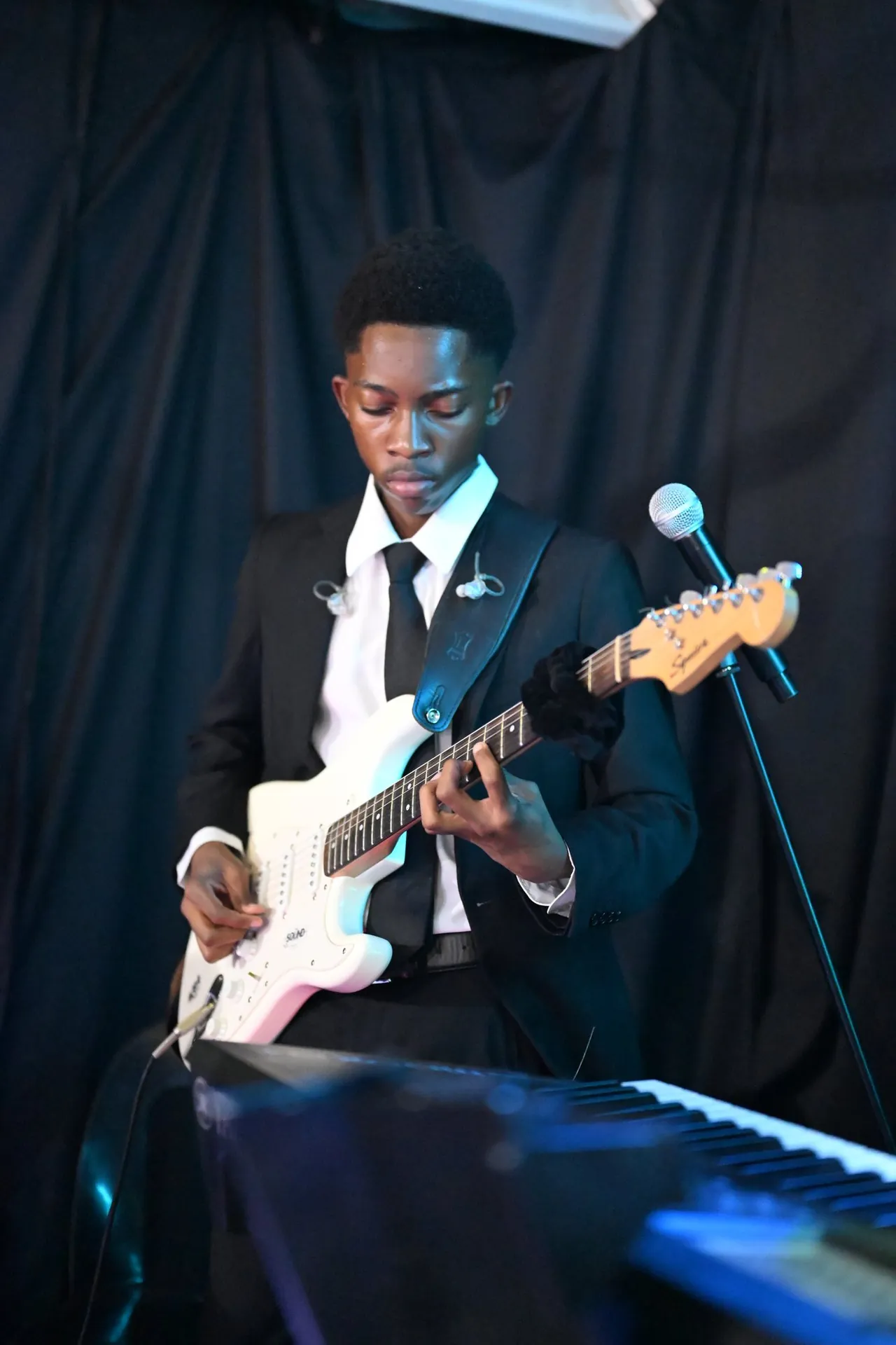 On guitar at Koinonia 25